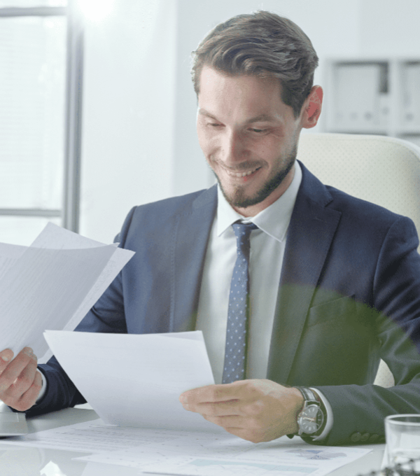 Businessman looking at documents smiling